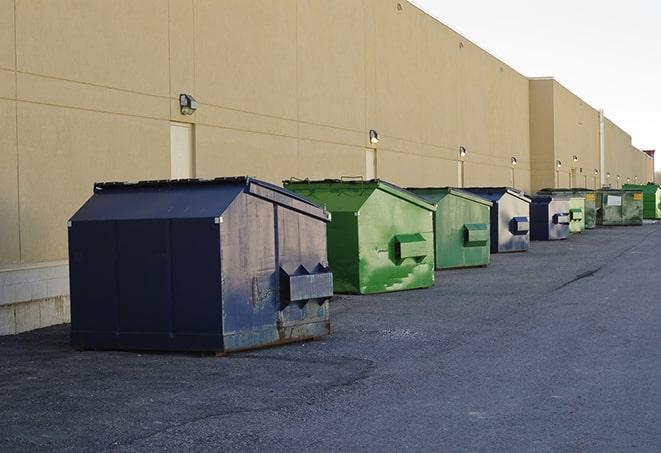 a red construction dumpster placed in front of a building under construction in Burgin